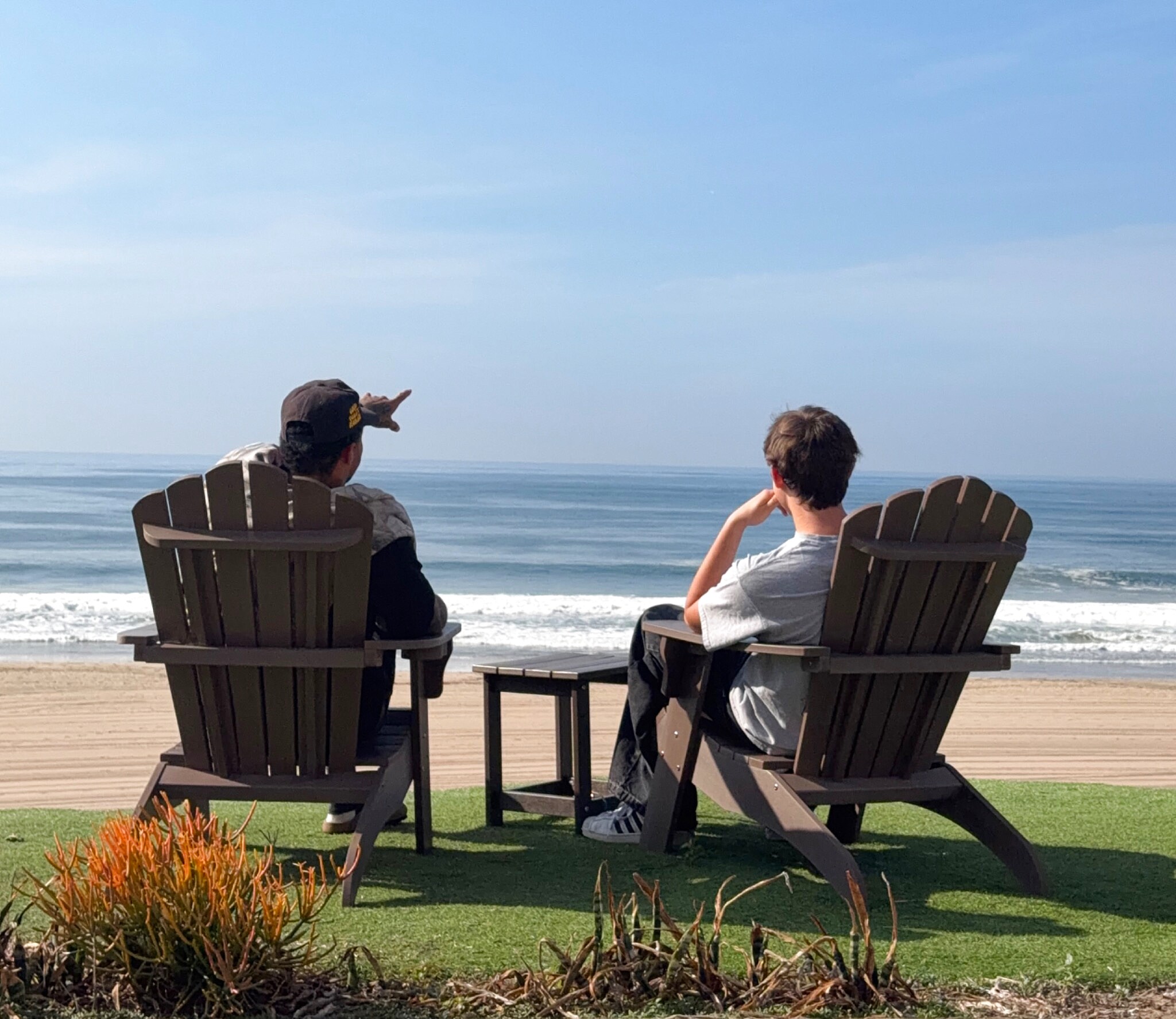 Recovery coach and young adult client in peaceful conversation overlooking the Pacific Ocean in Southern California - Off The Couch mentorship session